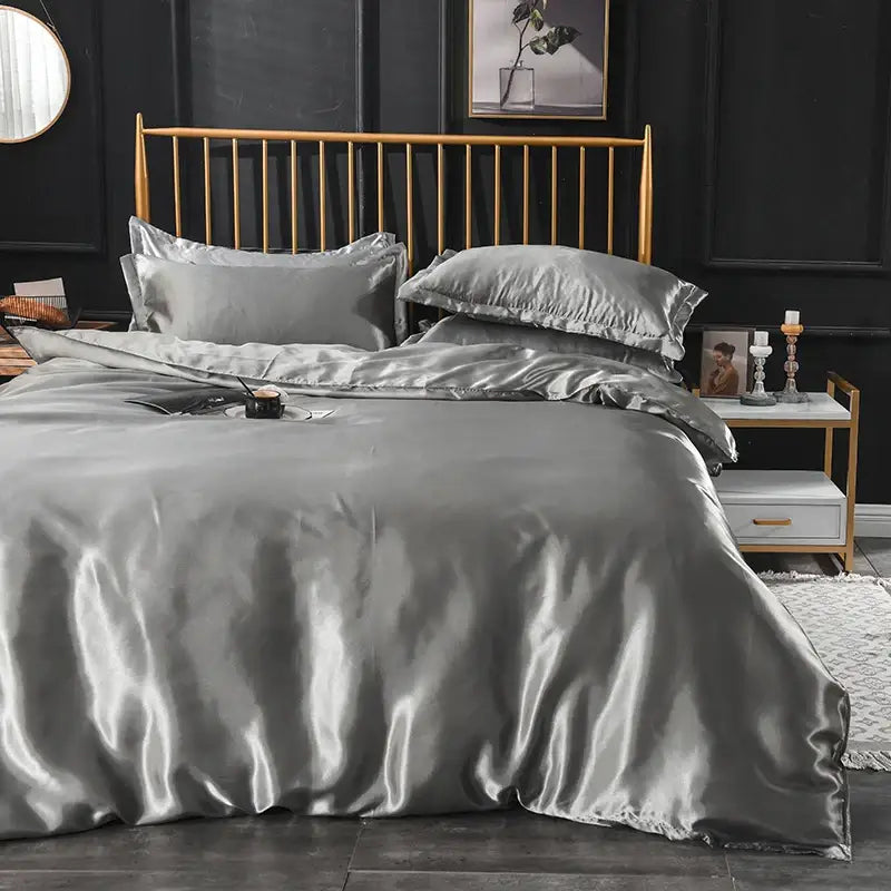 Silk-gray satin duvet cover bedding set with matching pillowcases featuring smooth lustrous finish and ruffled edges