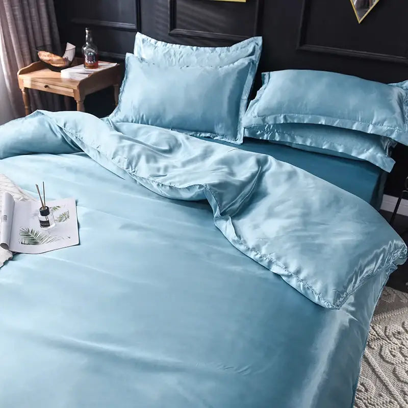 Light blue decorbites silk bedding set with smooth glossy satin finish and matching pillowcases in various sizes