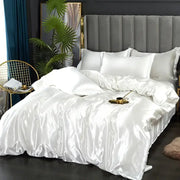 White satin duvet cover set with matching pillows featuring smooth glossy finish in various width bed sizes by DecorBites