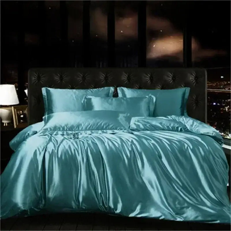 Teal satin decorbites luxurious silk bedding set with duvet cover and matching pillows on tufted black headboard