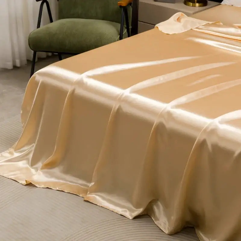 Beige satin bedding set from decorbites with a solid color flat sheet featuring a smooth glossy finish and subtle sheen