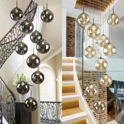 DecorBites™ luxurious spiral led chandelier featuring sleek spherical glass pendant lights in dark and amber hues