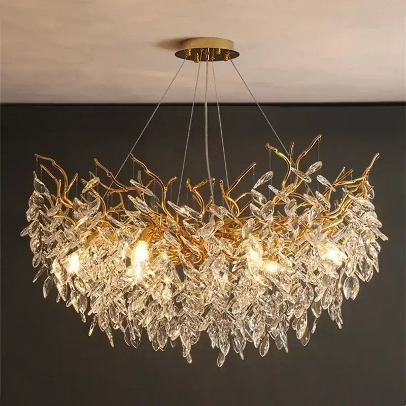 Gold-toned luxury crystal chandelier with intricate crystal leaf and branch design for elegant living room decor