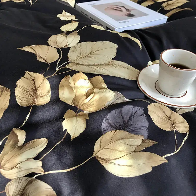 Black satin duvet cover with intricate gold and muted purple flamingo leaf patterns in egyptian cotton set including pillowcases