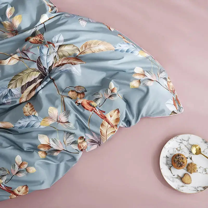 Decorbites luxury egyptian cotton duvet cover in light blue satin with tropical leaf print and vibrant red parrot design
