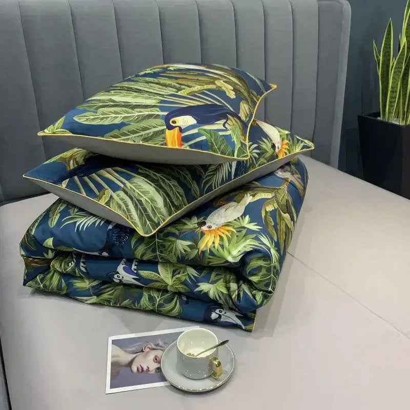 Stacked decorbites™ luxury egyptian cotton duvet cover set with vibrant toucan leaf pattern and matching pillowcases on deep blue