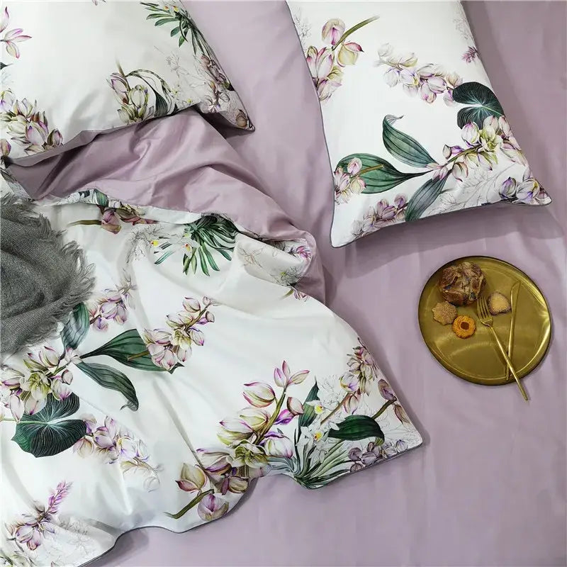 White duvet cover with pink and green orchid floral print and matching lavender satin pillowcases in egyptian cotton set
