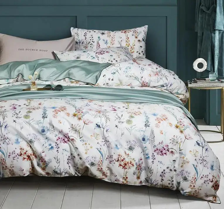 A soft white egyptian cotton duvet cover and matching pillowcases feature a pastel flamingo leaf floral pattern