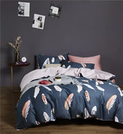 Navy blue feather-patterned duvet cover set with coordinating pillowcases in DecorBites Luxury Egyptian cotton bedding set