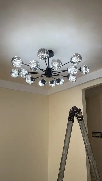 Modern black metal chandelier with multiple clear glass ball bulbs emitting warm light and dimmable via remote control
