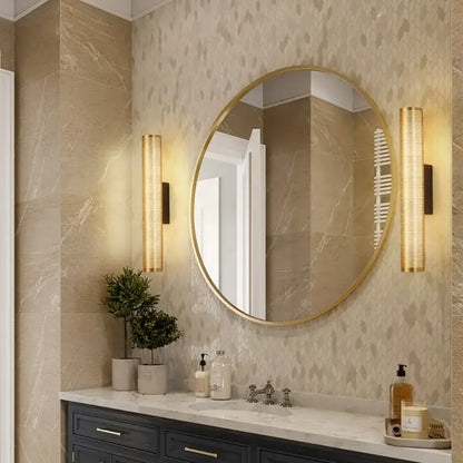 Gold-framed round mirror wall sconce with sleek modern design and luxury gold finish for elegant vanity decor
