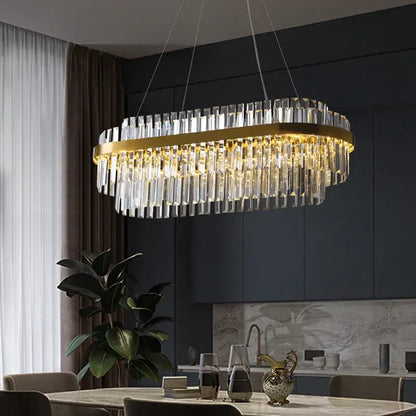 Gold-toned oval luxury led crystal chandelier with cascading clear crystal prisms for elegant home decor by decorbites