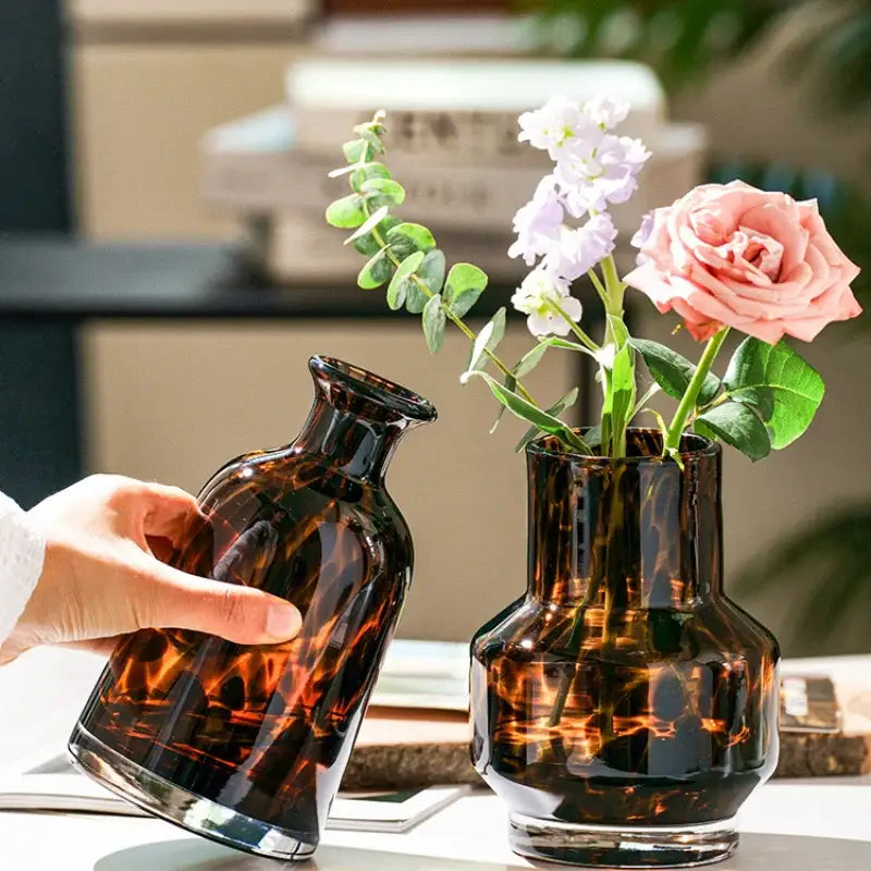 DecorBites luxury leopard glass vase in tortoiseshell amber holding a pink rose and white flowers for home decor