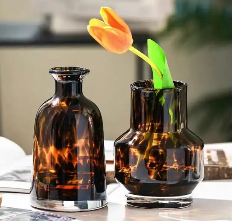 Two amber-tinted luxury leopard glass vases with tortoiseshell pattern for elegant home decor by DecorBites