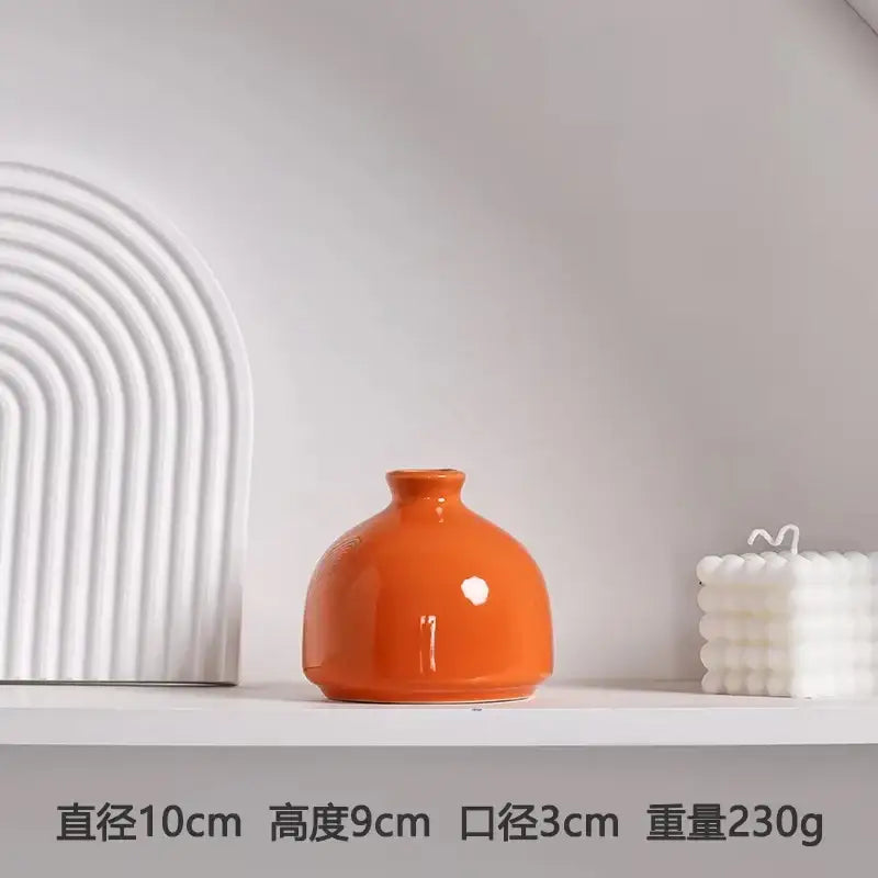 Glossy orange luxury modern ceramic vase with rounded body and narrow neck by DecorBites™ for elegant decor