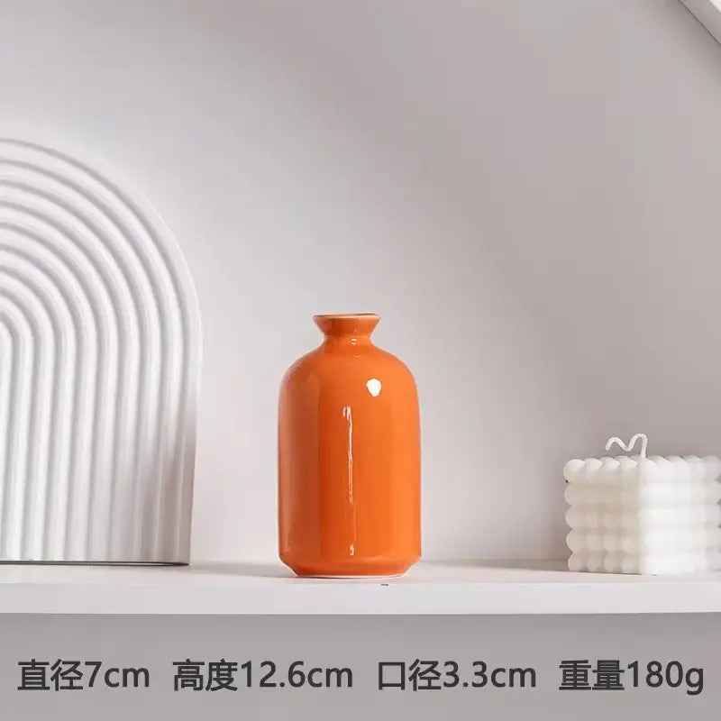 Glossy orange luxury modern ceramic vase with rounded body and narrow neck by DecorBites™ for elegant decor