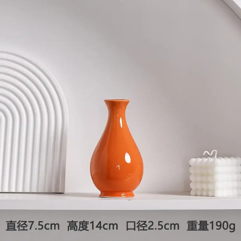 Glossy orange luxury modern ceramic vase with a slender neck and rounded body by DecorBites™