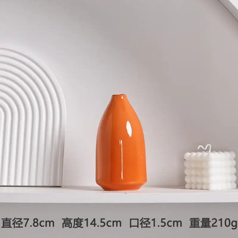 A sleek orange luxury modern ceramic vase with a tapered shape and smooth rounded base by DecorBites™