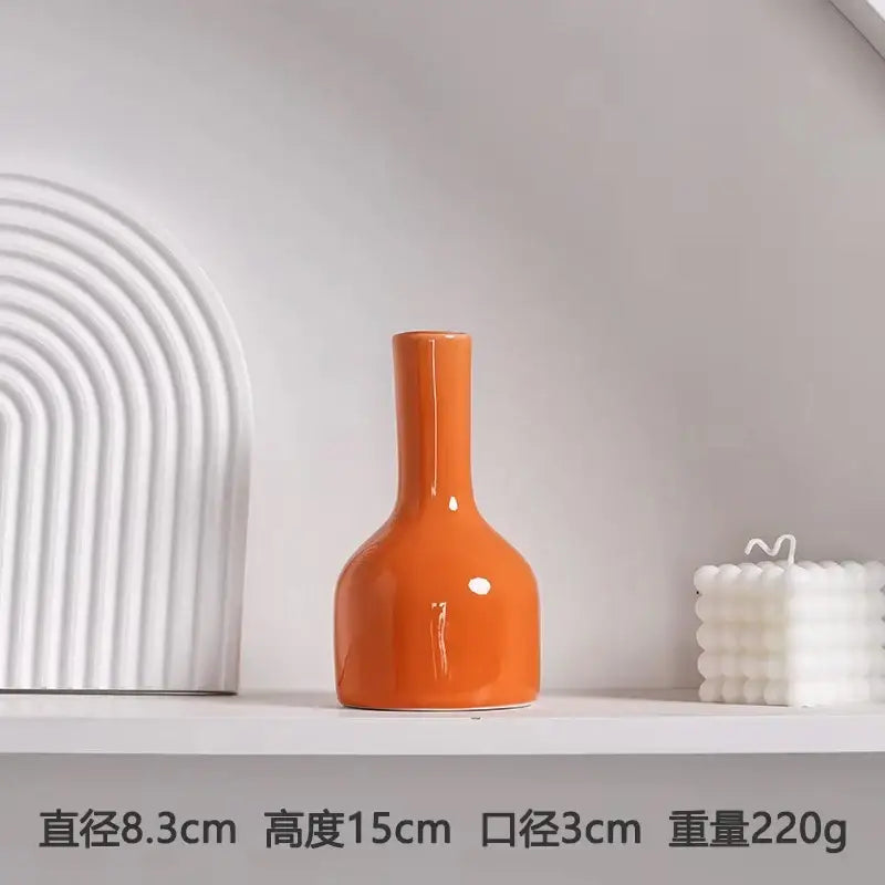 DecorBites luxury modern ceramic vase in orange with a sleek glossy finish, slender neck, and rounded base