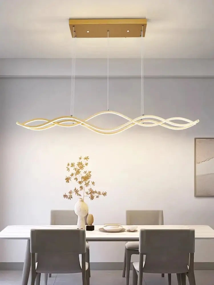Gold-toned modern led pendant light with sleek wavy design and three intertwined arms for dining room luxury nordic chandeliers