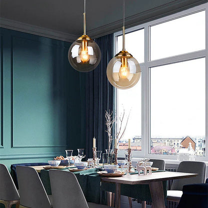 Two modern pendant lights with gold metal fixtures and smoked glass shades in a luxury nordic led chandelier for dining room