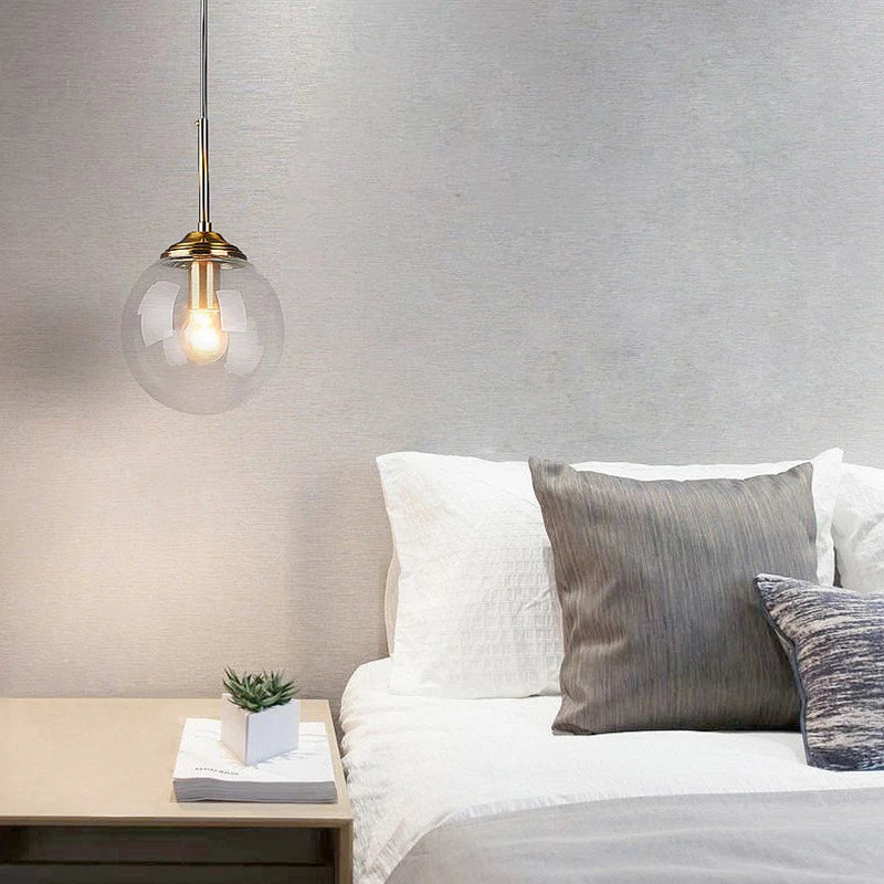DecorBites™ luxury nordic led chandelier with clear glass globe and brass accents hanging above bed for dining room use