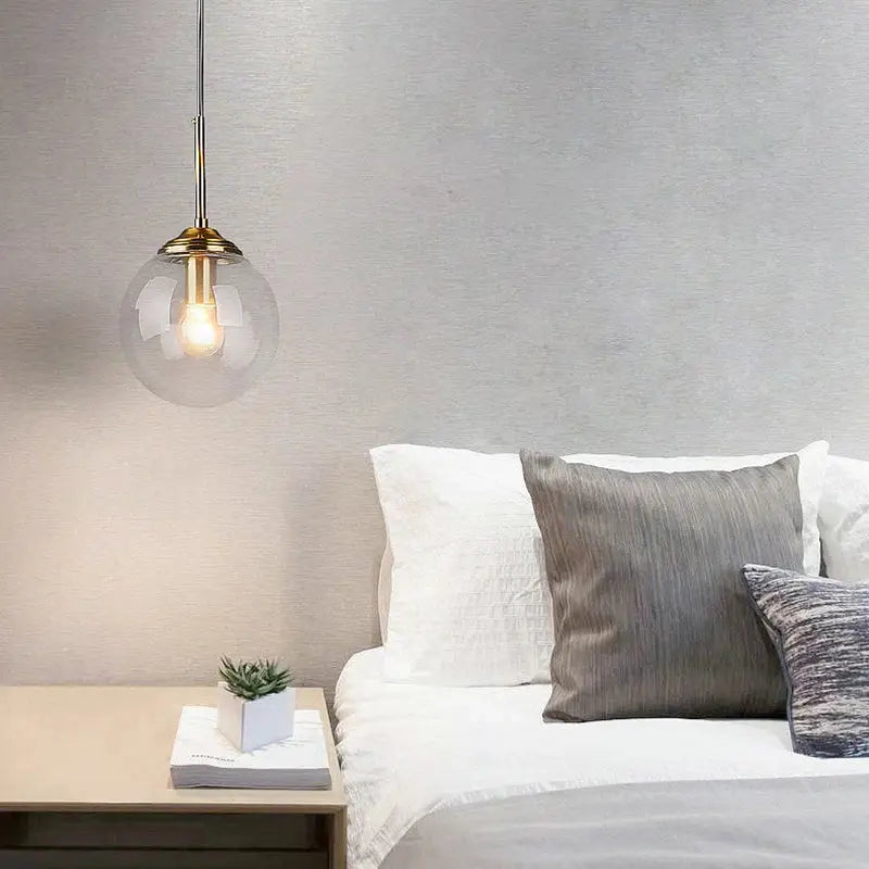 DecorBites™ luxury nordic led chandelier with clear glass globe and brass accents hanging above bed for dining room use