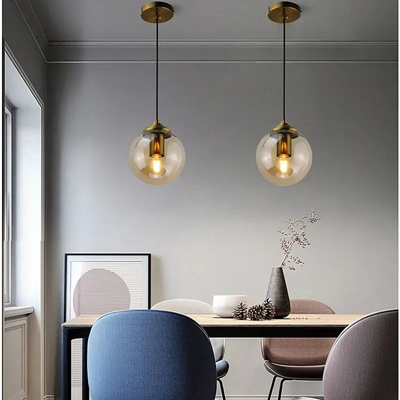 Two brass-finished pendant lights with spherical smoked glass shades in decorbites luxury nordic led chandelier for dining room