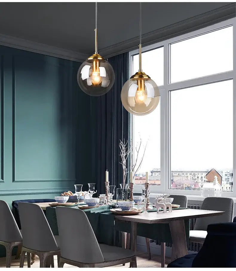 Two hanging globe pendant lights with brass-finished fixtures and glass shades in decorbites luxury nordic led chandelier for dining room