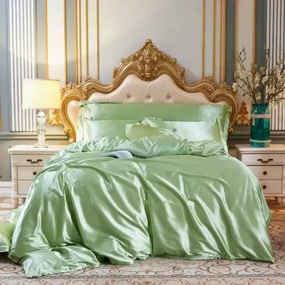 Luxurious sage green silk bedding set with duvet cover and fitted sheet displayed on ornate gold headboard