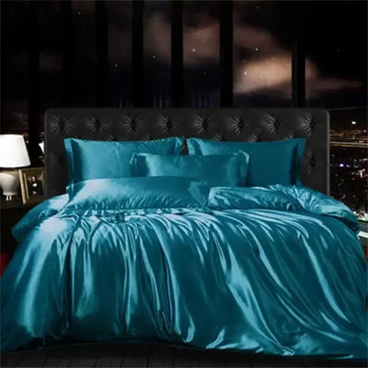 Teal satin DecorBites™ luxury silk bedding set with duvet cover fitted sheet and matching pillows on tufted headboard
