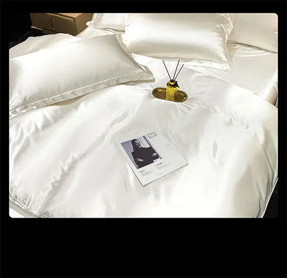 White satin DecorBites™ luxury silk bedding set with duvet cover and fitted sheet featuring a glossy finish and matching pillows