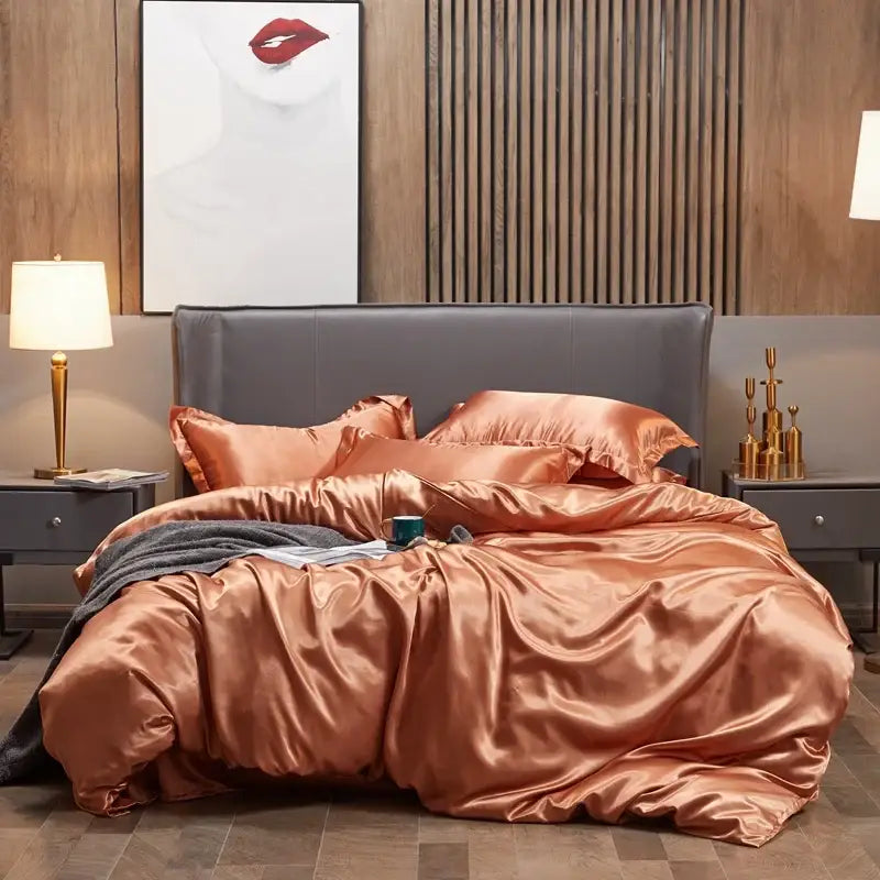 Copper satin four-piece solid color bedding set with matching pillows and plush gray headboard for width bed