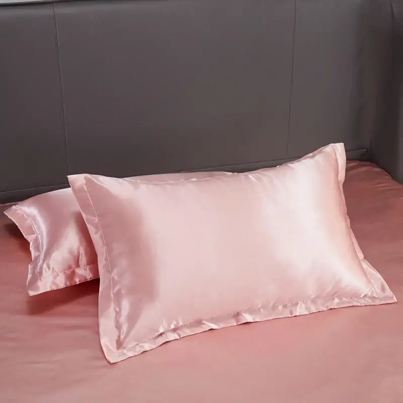 Pink satin pillowcase with a smooth glossy finish from DecorBites™ luxury solid color bedding set for width bed use