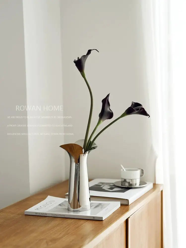 DecorBites™ luxury stainless steel vase with sleek metallic finish and wooden accent holding black calla lilies