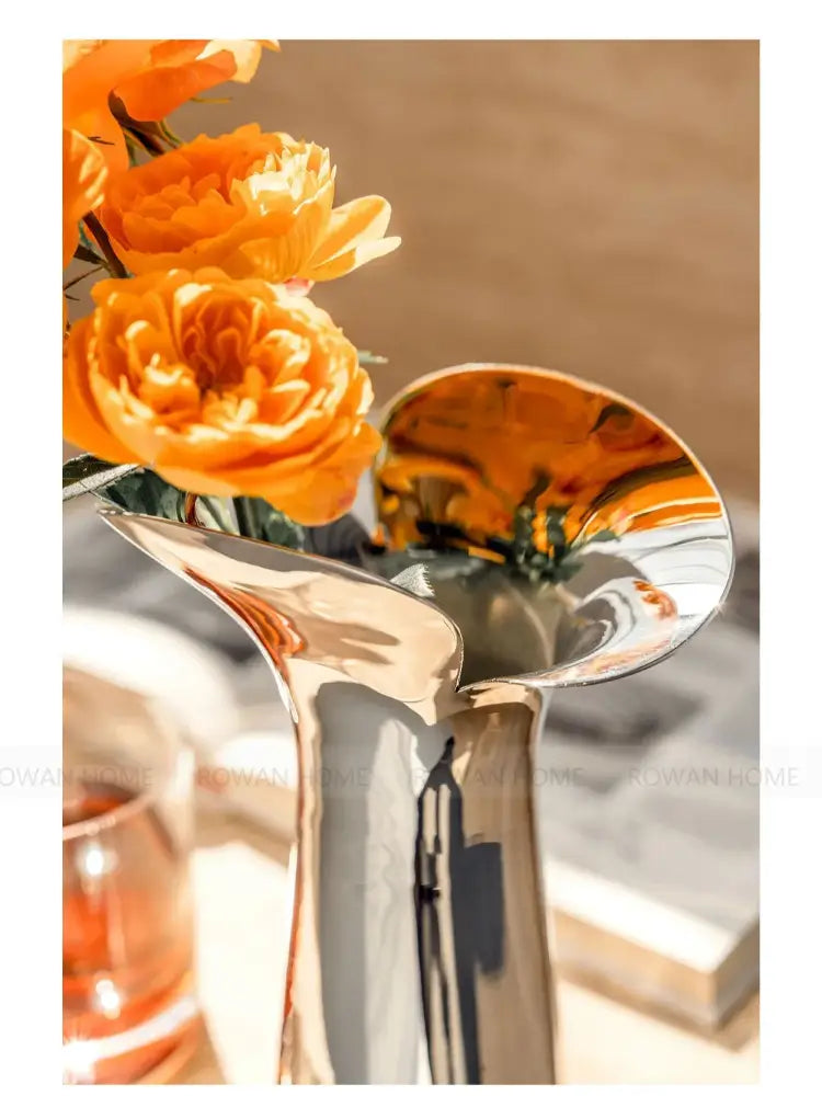 DecorBites™ luxury stainless steel vase with sleek modern design holding vibrant orange flowers for home decor