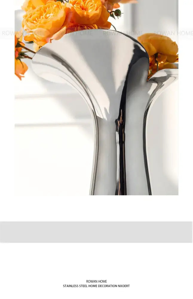 Shiny silver luxury stainless steel vase with sleek modern design for elegant home decor by DecorBites