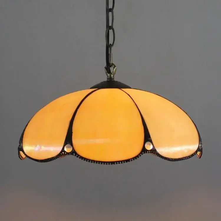 DecorBites™ luxury Tiffany style stained glass pendant light in warm amber with black metal frame and chain