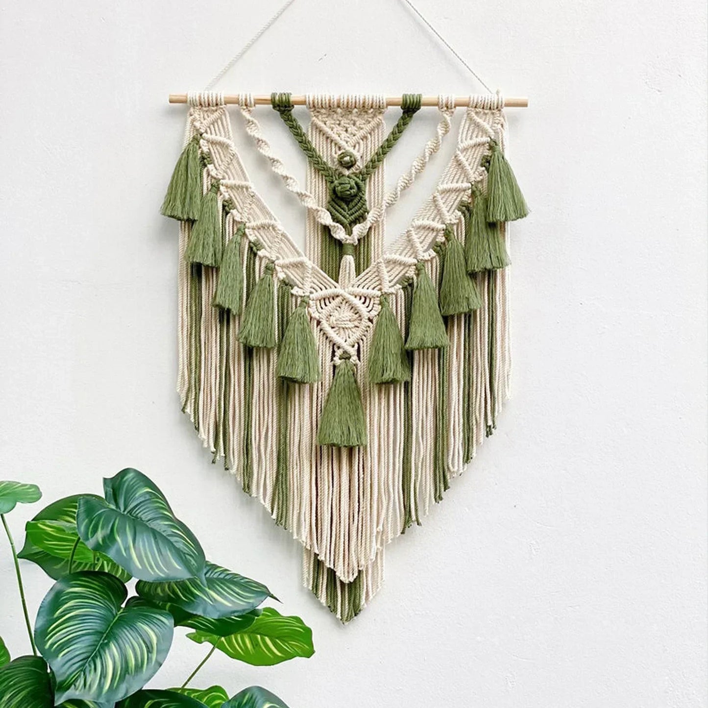 Cream and olive green macrame wall hanging with tassels for chic bohemian home decor by DecorBites