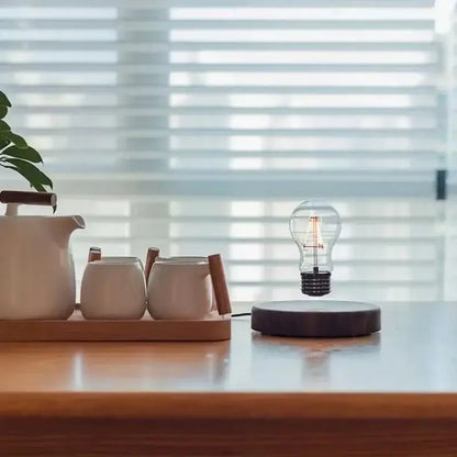A clear glass bulb floats above a dark wooden base in the DecorBites magnetic levitation lamp for home decor