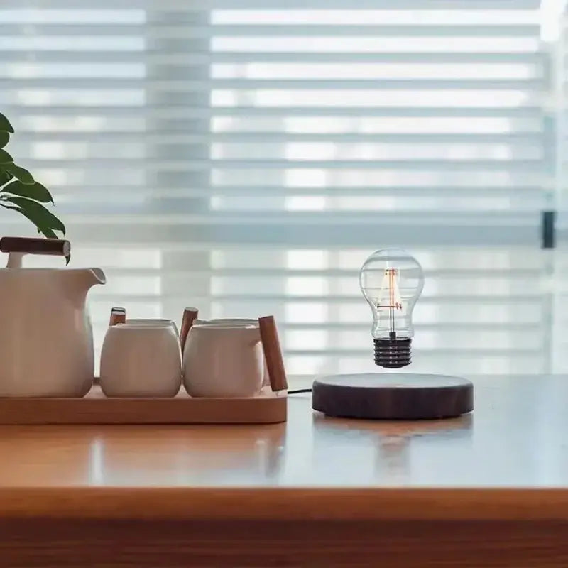 A clear glass bulb floats above a dark wooden base in the DecorBites magnetic levitation lamp for home decor