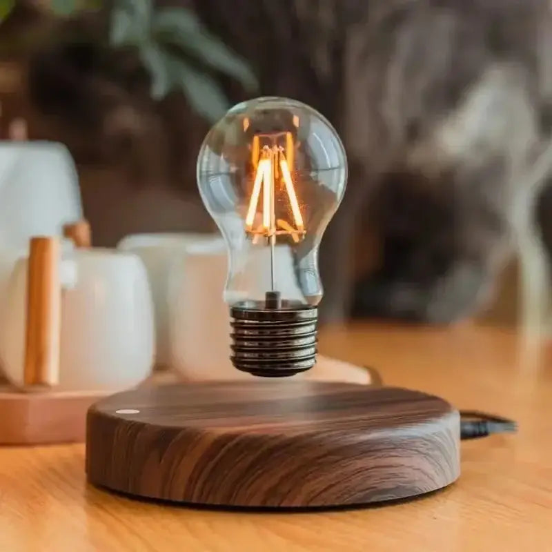 Decorbites magnetic levitation lamp with a floating warm-glow glass LED bulb above a dark wood base for home office use