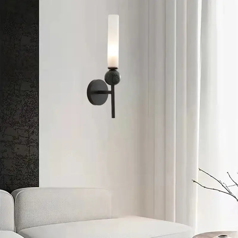 Modern black metal marble sconce by DecorBites with frosted glass cylinder and spherical accent for wall lighting