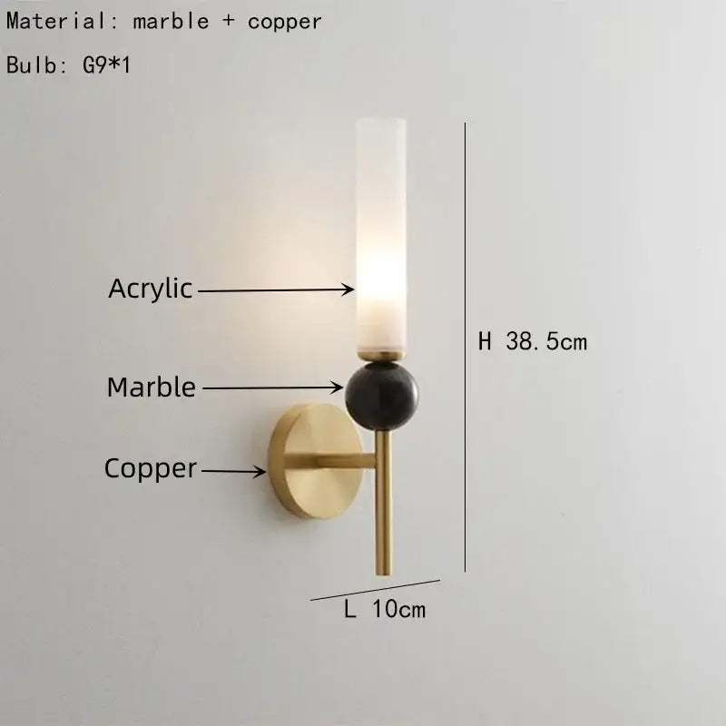 A modern decorbites marble sconce wall light with brass copper base, black marble sphere, and warm acrylic diffuser lighting
