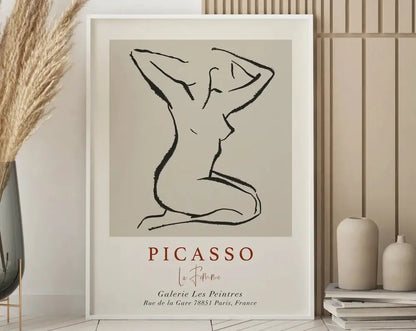 Minimalist framed art print featuring a black line drawing of a nude figure on beige background by picasso for floral art prints decor