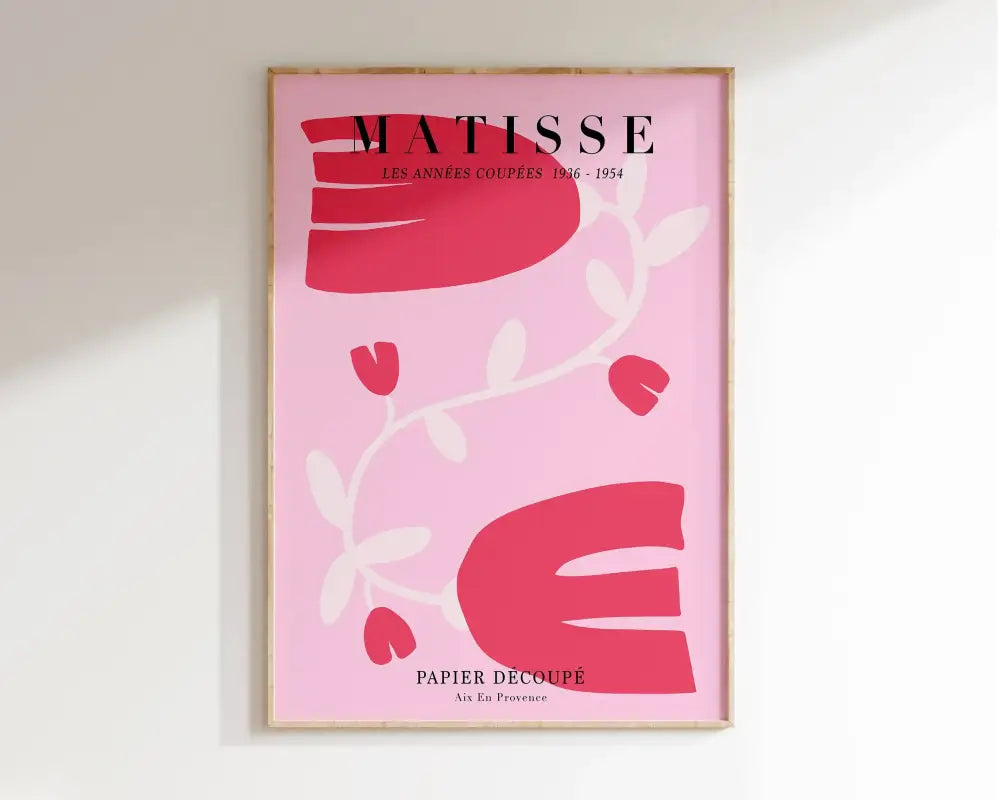 A framed pink paper-cut art print from the decorbites market matisse collection featuring bold red and white shapes
