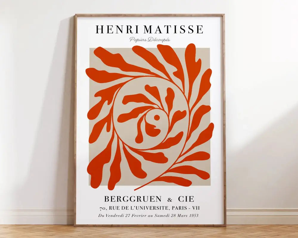A framed DecorBites™ matisse floral art print with a bold orange leafy spiral design on beige background