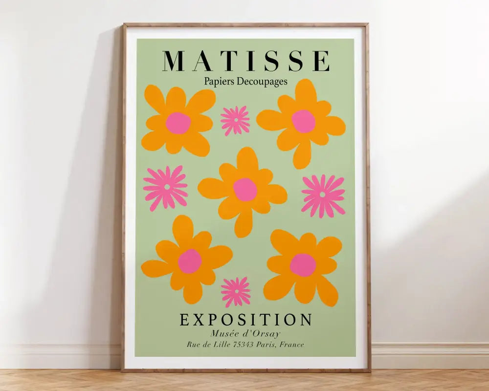 A framed poster from DecorBites featuring bold orange and pink abstract flowers matisse on a light green background