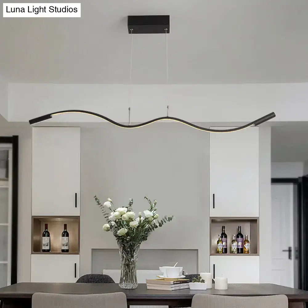 Modern black metal minimalist pendant light fixture with sleek curved design and integrated LED for dining room island