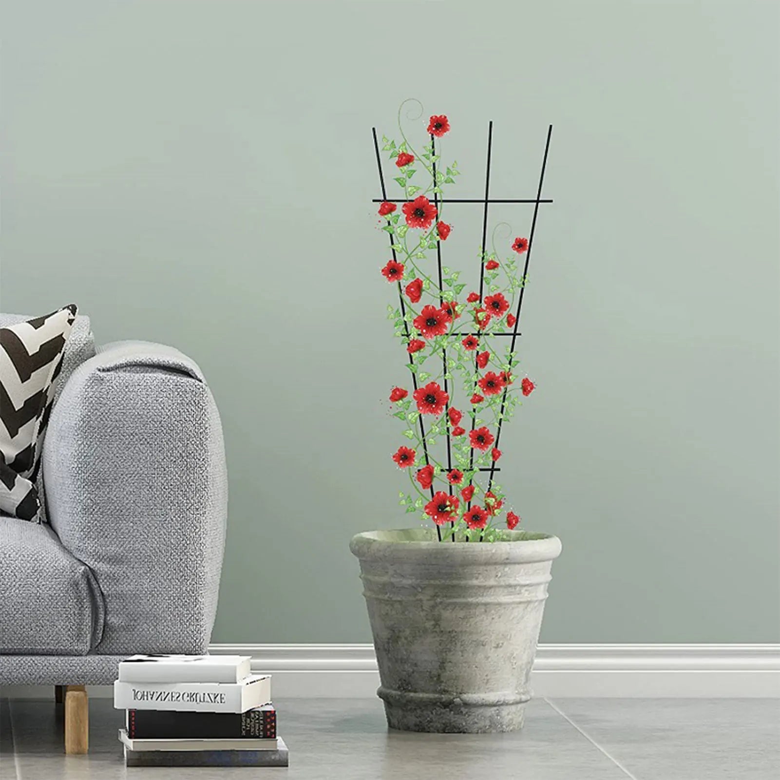Red poppy flowers climb a black metal garden plant stand in a textured gray pot for indoor and outdoor growth